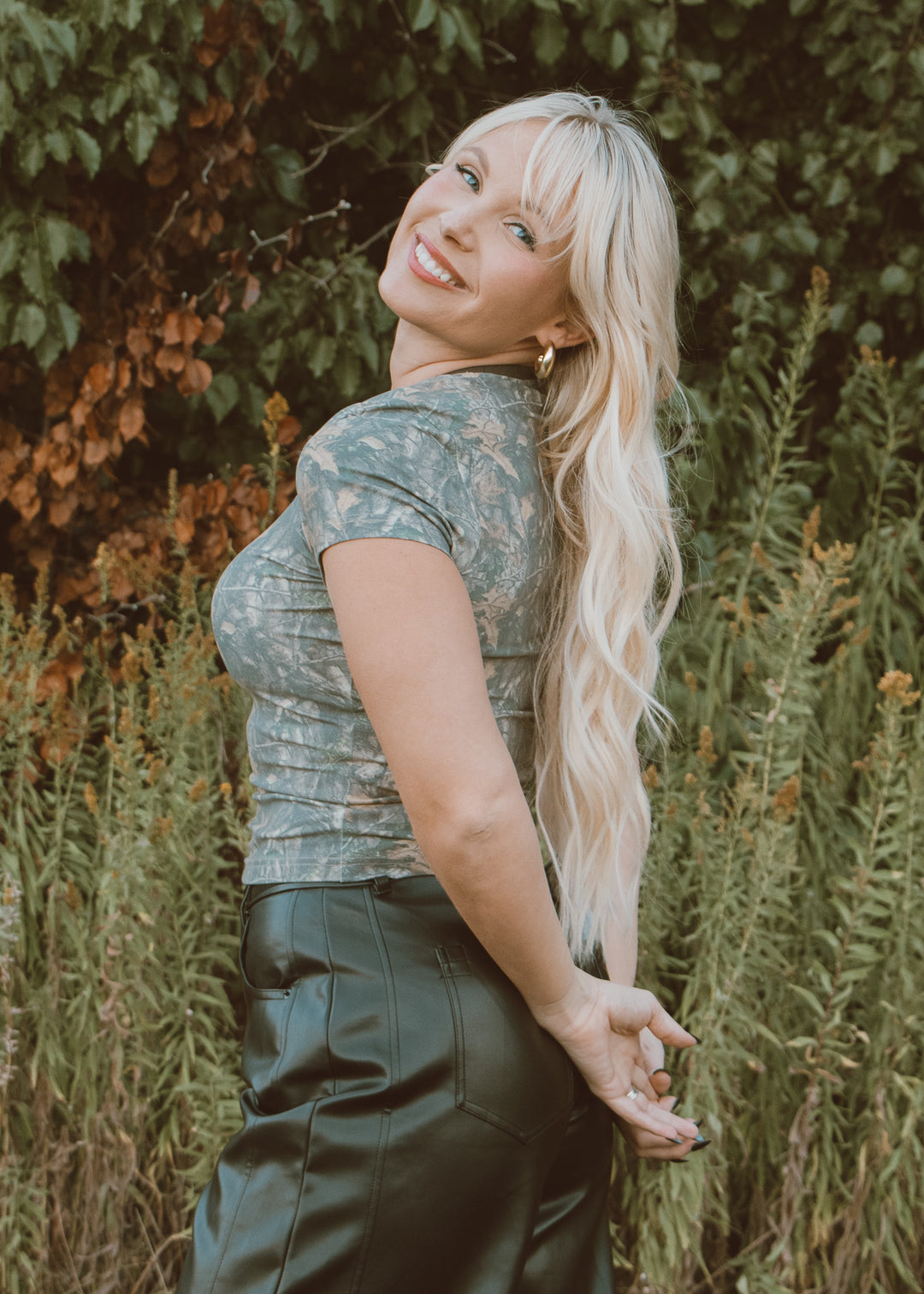 camo tee shirt and leather pants.
