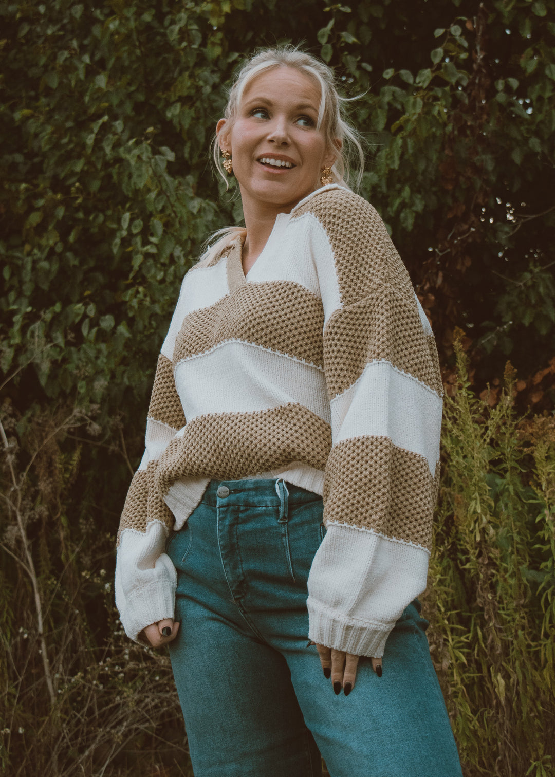 Green and white crochet sweater and jeans.