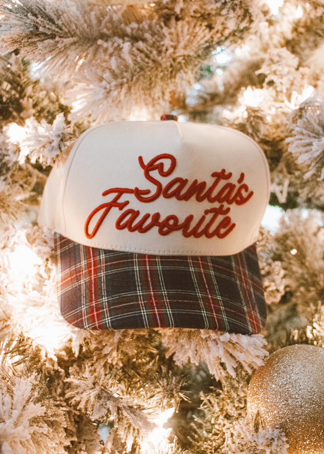 Cap with 'Santa's Favorite' text on a Christmas tree