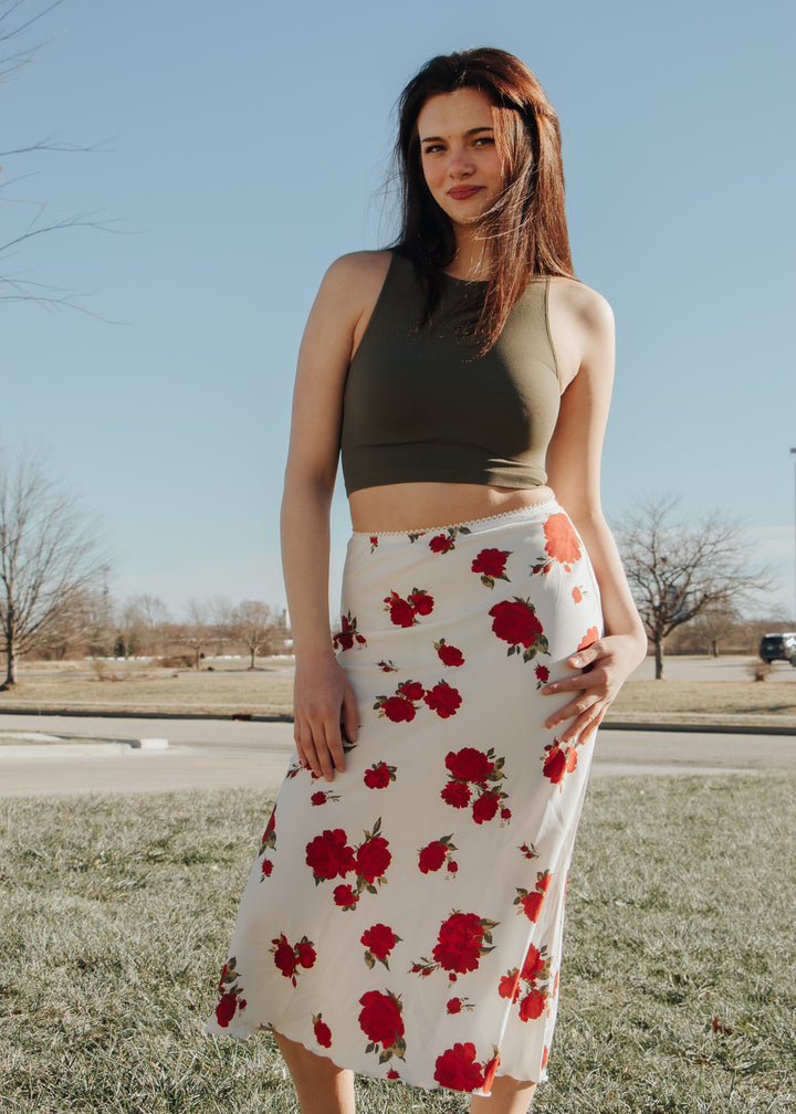 Woman wearing a floral skirt and crop top outdoors