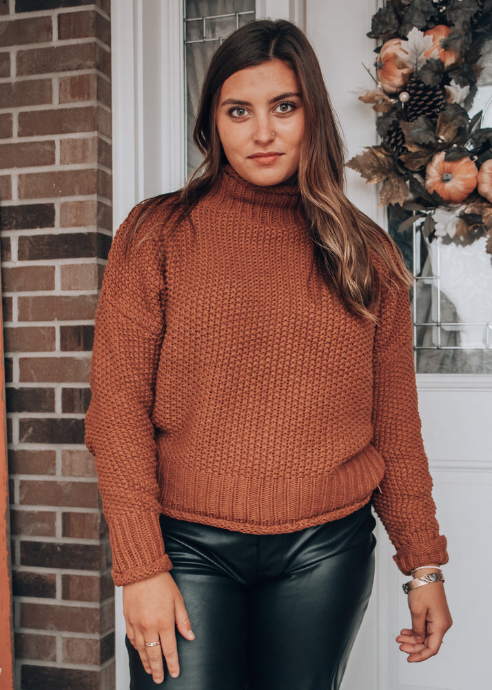 Brown sweater paired with black leather pants 