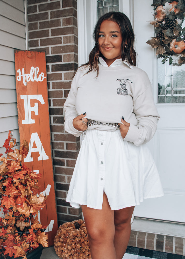 sweater paired with a white button down dress