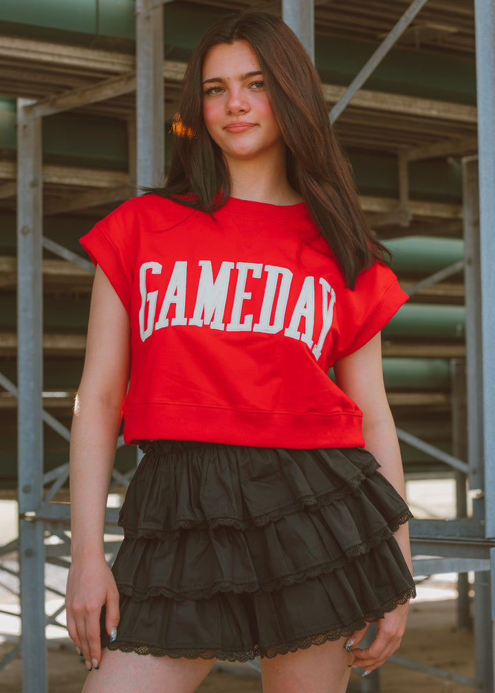 Woman wearing a red gameday top