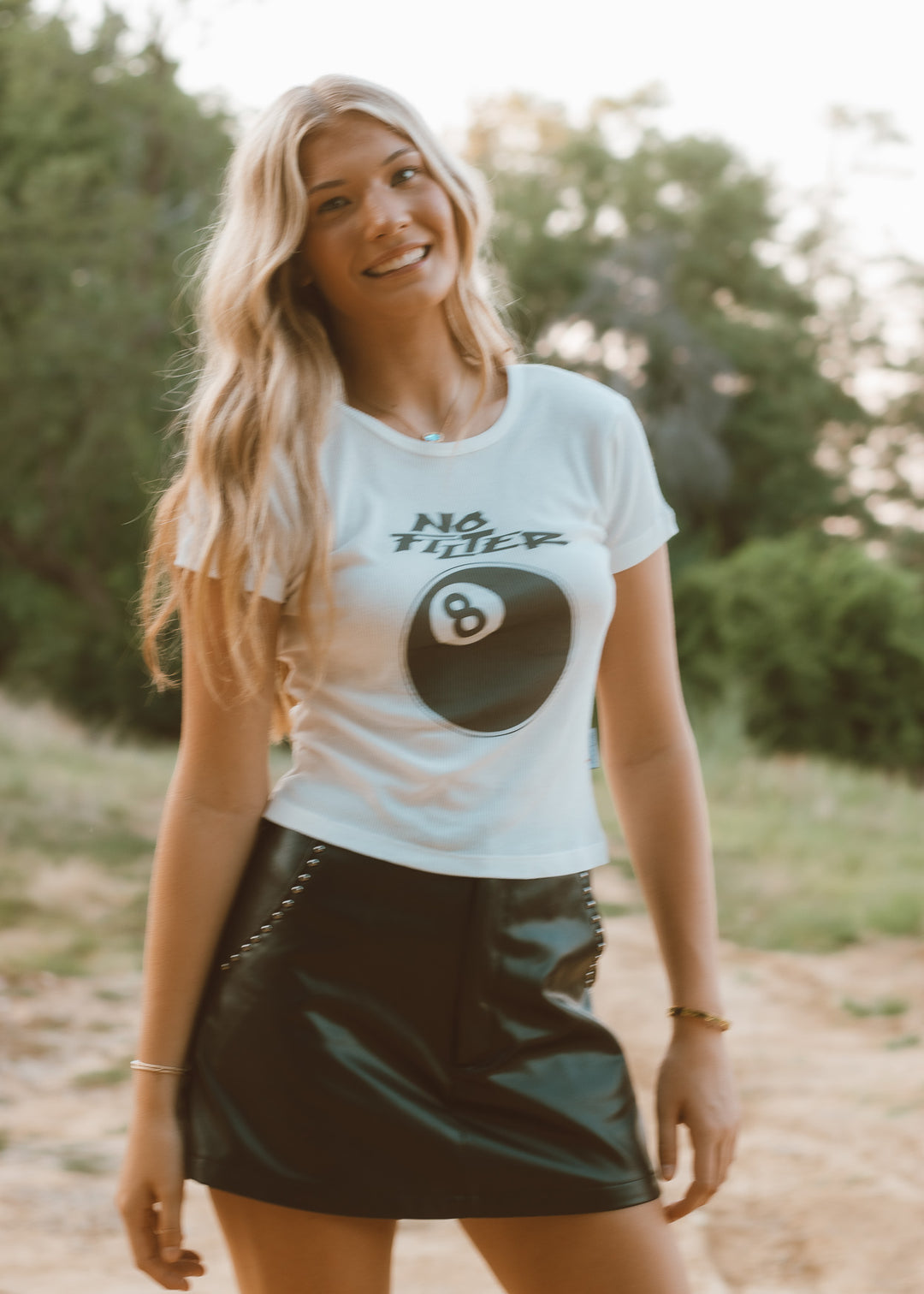 Woman wearing a white t-shirt with a graphic design outdoors