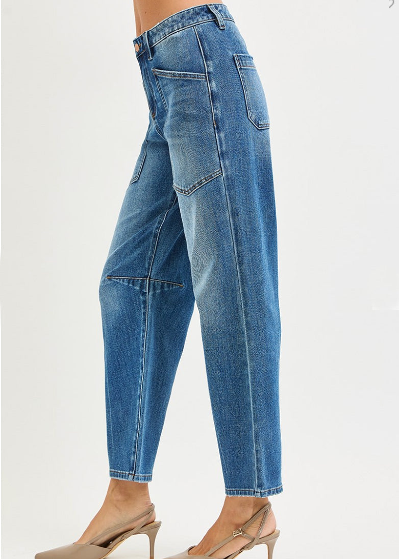 Blue jeans worn by a person on a white background